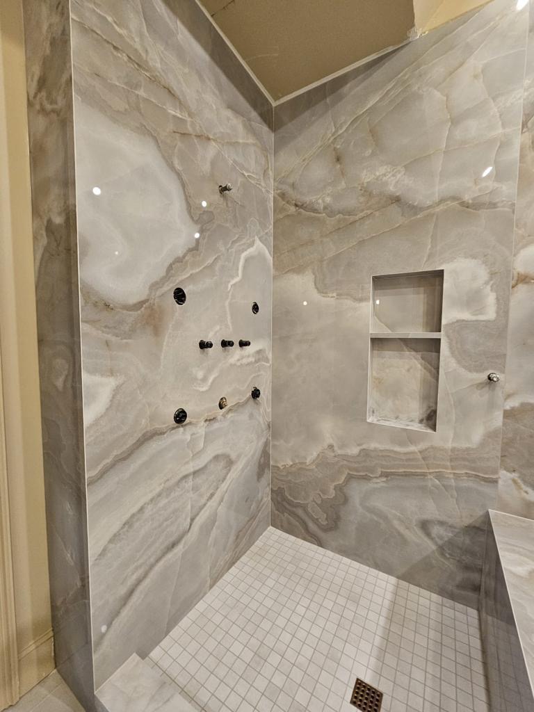 Marble slab shower walls with mosaic tile floor